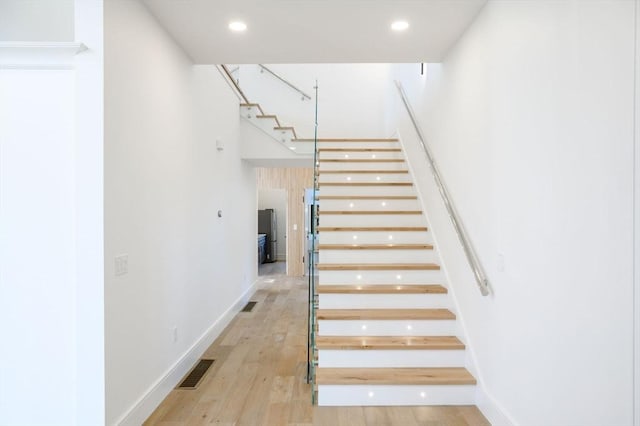 stairs with hardwood / wood-style flooring