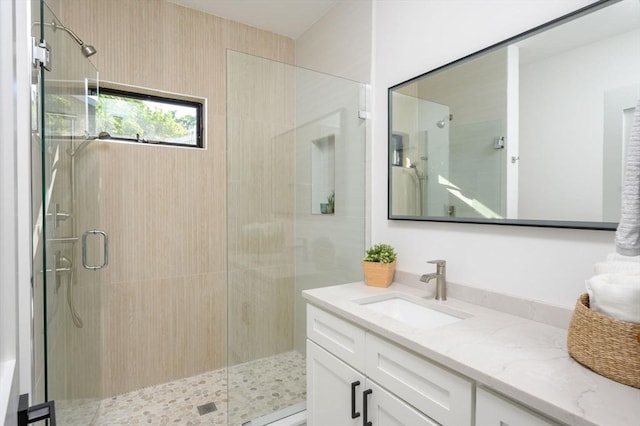 bathroom featuring an enclosed shower and vanity