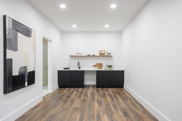 bar featuring sink and dark hardwood / wood-style floors