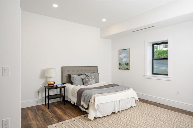 bedroom with dark hardwood / wood-style flooring
