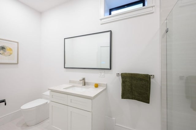 bathroom featuring vanity, toilet, and a shower with door