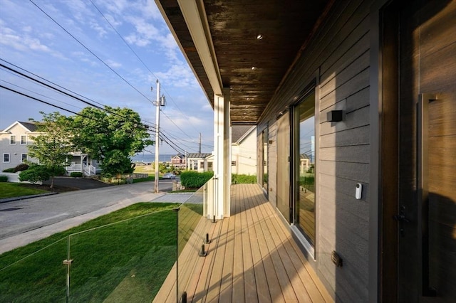 wooden terrace with a lawn