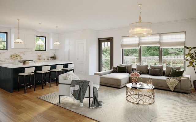 living room with light wood-type flooring and ornamental molding