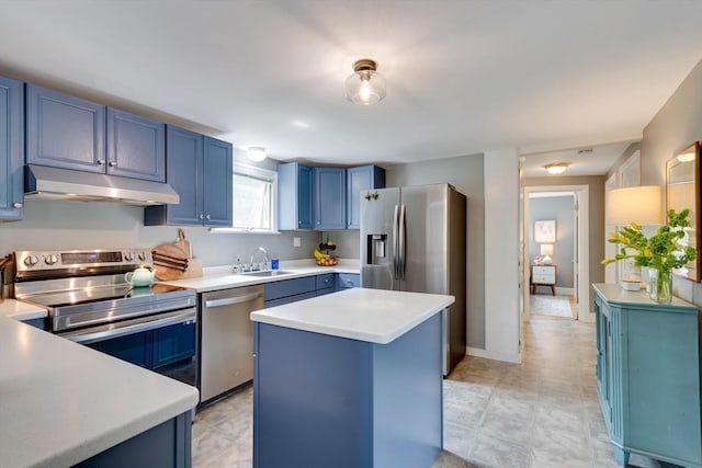 477 Laws Brook Rd, Concord, MA 01742 - kitchen with under cabinet range hood, stainless steel appliances, blue cabinets, a sink, and light countertops