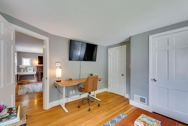 477 Laws Brook Rd, Concord, MA 01742 - office area featuring light wood-style floors, baseboards, and a brick fireplace