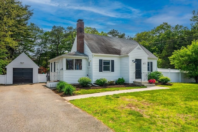 477 Laws Brook Rd, Concord, MA 01742 - view of front facade with an outbuilding, a chimney, a detached garage, asphalt driveway, and roof with shingles