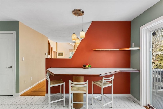 dining area featuring baseboards