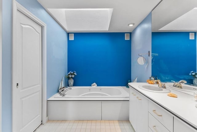 bathroom with visible vents, a garden tub, and vanity