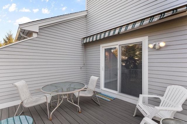 wooden terrace with outdoor dining area