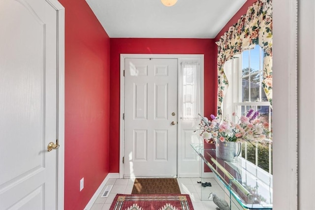 tiled foyer with baseboards