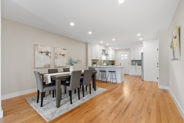 dining room featuring light hardwood / wood-style floors and sink