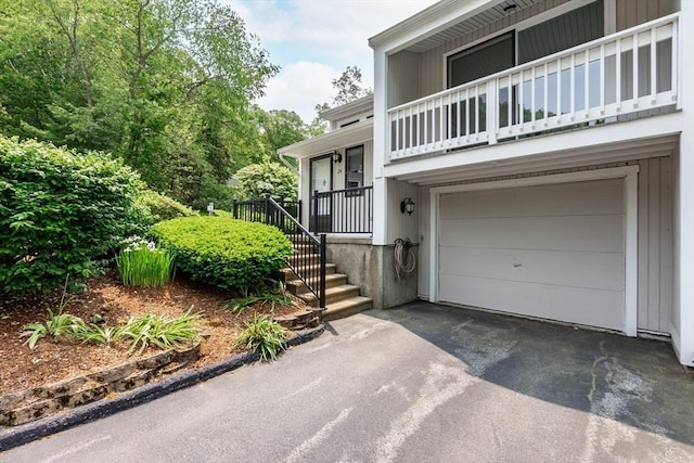 24 Coventry Rd Unit 24, Grafton, MA 01519 - doorway to property featuring a garage, asphalt driveway, and a balcony