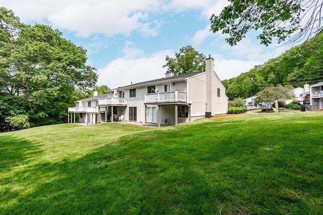 24 Coventry Rd Unit 24, Grafton, MA 01519 - rear view of house with a chimney, a yard, and a wooden deck