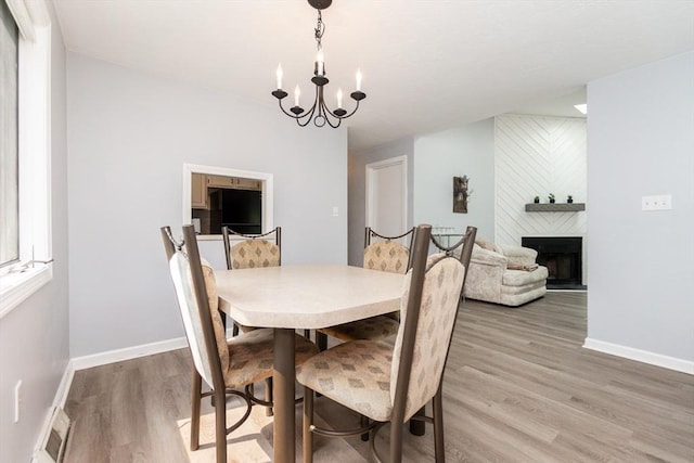 24 Coventry Rd Unit 24, Grafton, MA 01519 - dining space featuring a chandelier, light wood-style flooring, and a large fireplace
