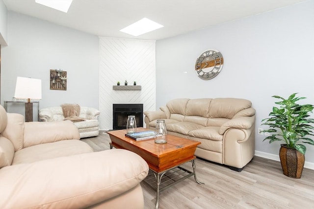 24 Coventry Rd Unit 24, Grafton, MA 01519 - living area featuring a skylight, light wood-style flooring, and a large fireplace