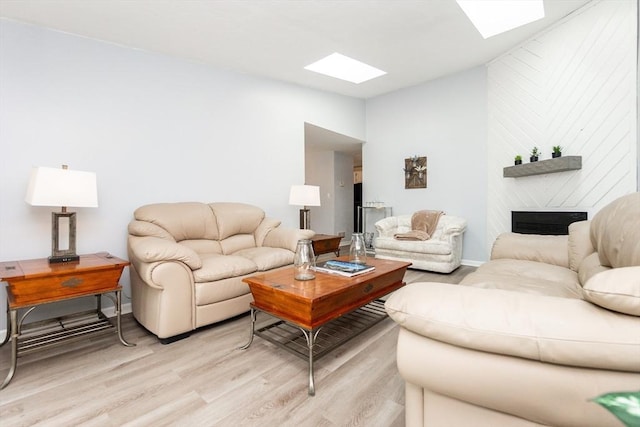 24 Coventry Rd Unit 24, Grafton, MA 01519 - living room featuring light wood finished floors, lofted ceiling, a skylight, and a large fireplace