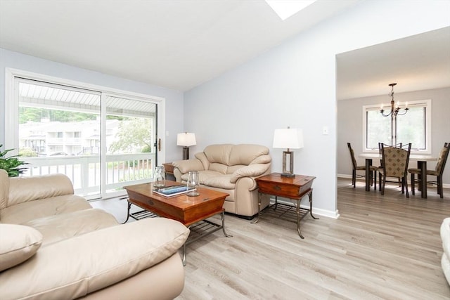 24 Coventry Rd Unit 24, Grafton, MA 01519 - living area with a chandelier, light wood finished floors, and vaulted ceiling