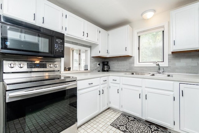 24 Coventry Rd Unit 24, Grafton, MA 01519 - kitchen featuring stainless steel range with electric cooktop, black microwave, light countertops, and white cabinetry