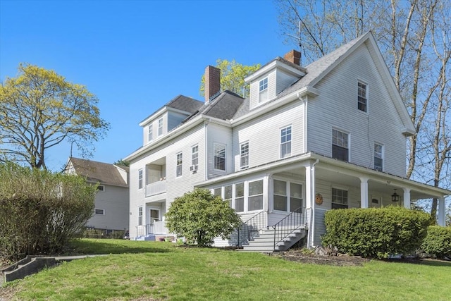 view of front facade featuring a chimney and a front yard