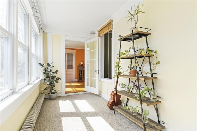 hall with carpet floors and french doors