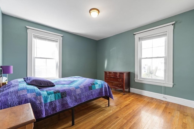bedroom with baseboards and light wood-type flooring