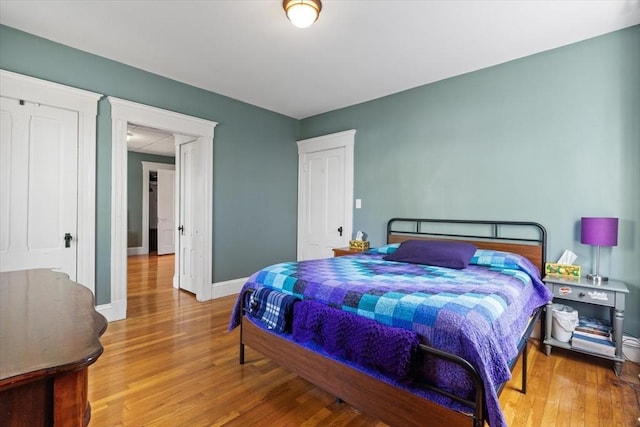 bedroom with baseboards and wood finished floors