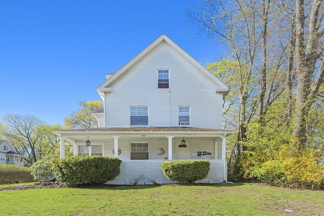 country-style home with a porch and a front lawn