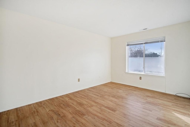 spare room featuring light wood-type flooring