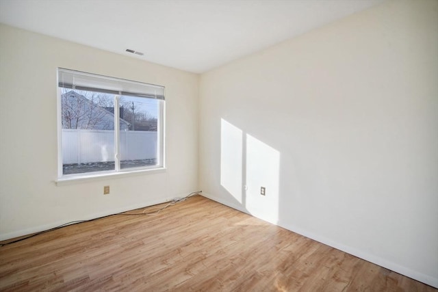 unfurnished room with light wood-type flooring