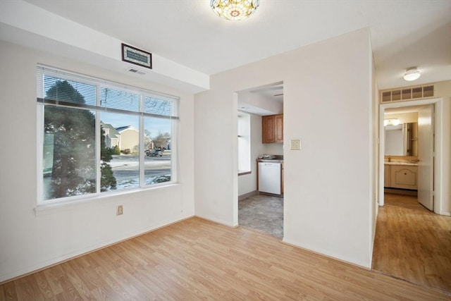 unfurnished living room featuring light hardwood / wood-style floors and a healthy amount of sunlight