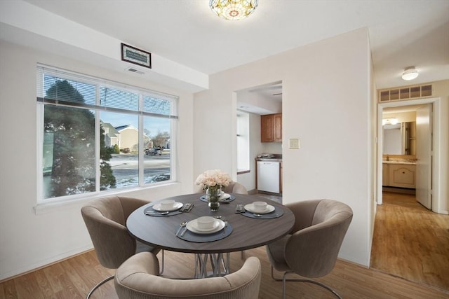 dining space featuring light wood-type flooring