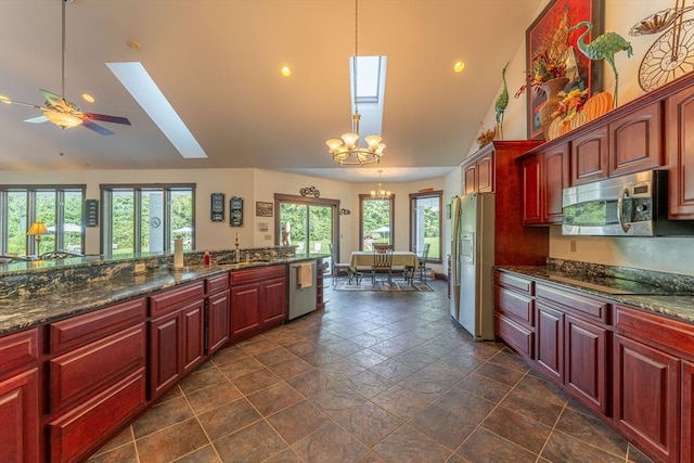 kitchen with decorative light fixtures, a skylight, a healthy amount of sunlight, and appliances with stainless steel finishes