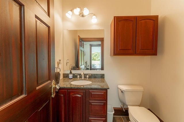 bathroom with vanity, tile patterned floors, and toilet