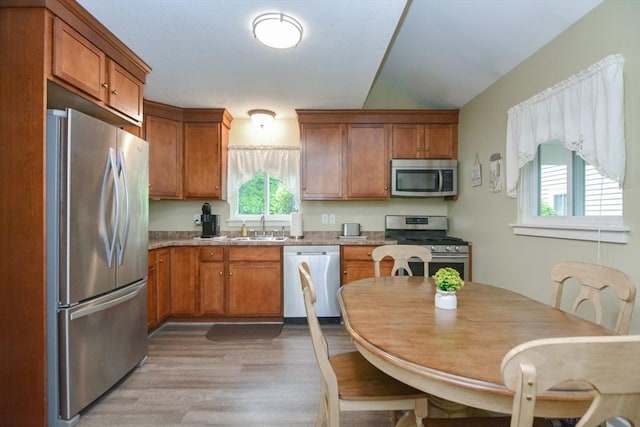 503 Dongary Rd Unit 503, Easton, MA 02375 - kitchen with stainless steel appliances, brown cabinets, light wood-style flooring, and lofted ceiling