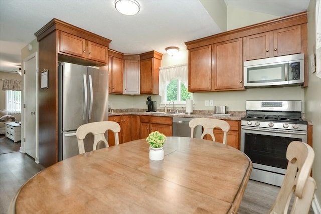 503 Dongary Rd Unit 503, Easton, MA 02375 - kitchen with appliances with stainless steel finishes, dark wood-type flooring, light countertops, and brown cabinetry