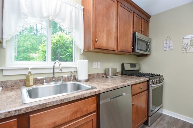 503 Dongary Rd Unit 503, Easton, MA 02375 - kitchen with stainless steel appliances, brown cabinets, dark wood-type flooring, and light countertops