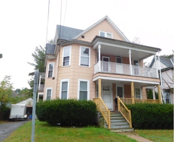 view of front of house with a balcony and covered porch