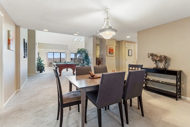 carpeted dining space with billiards and a textured ceiling