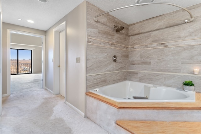 bathroom featuring tiled shower / bath combo and a textured ceiling