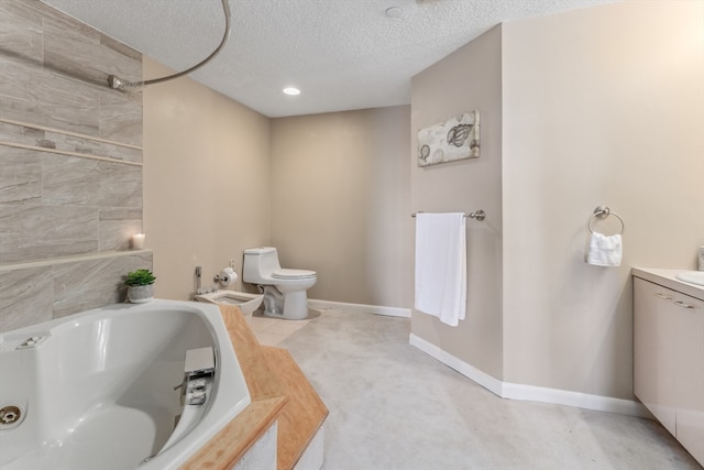 bathroom featuring toilet, a bidet, vanity, a textured ceiling, and a bathing tub