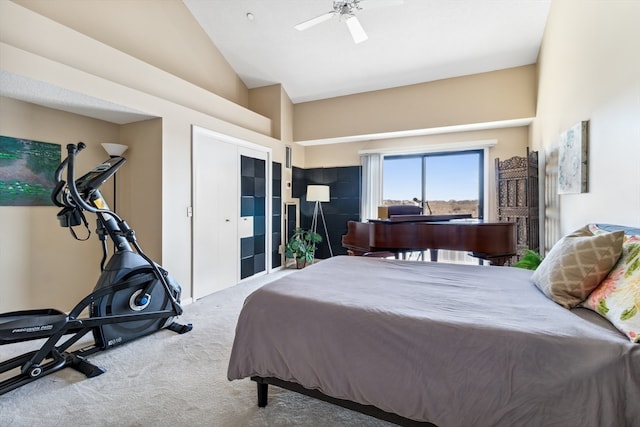 carpeted bedroom featuring high vaulted ceiling and ceiling fan