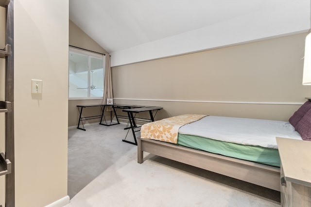 bedroom featuring light carpet and vaulted ceiling