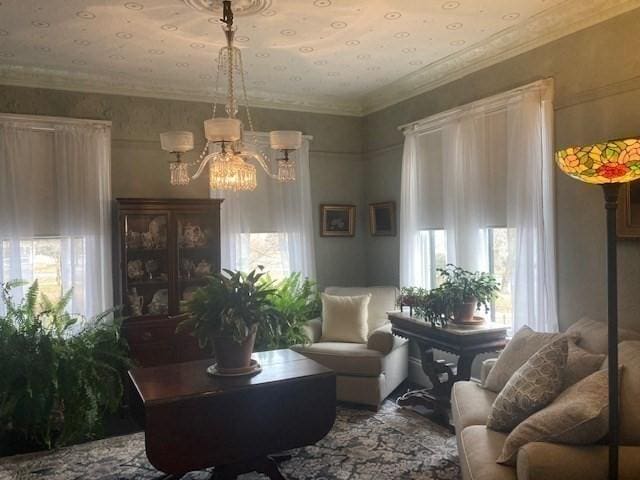 living area featuring crown molding and a chandelier