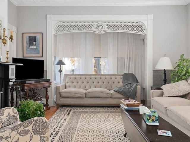 living room featuring hardwood / wood-style flooring and ornamental molding