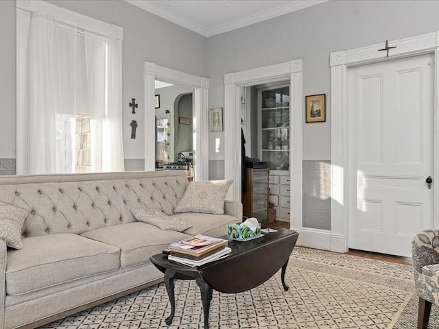 living room featuring light hardwood / wood-style floors and crown molding