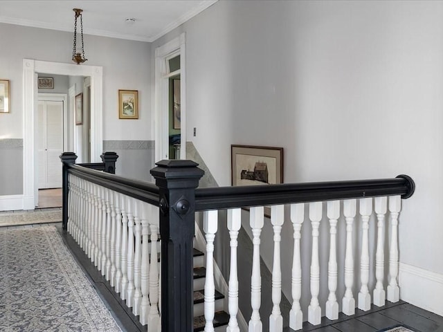 staircase with tile patterned floors and ornamental molding