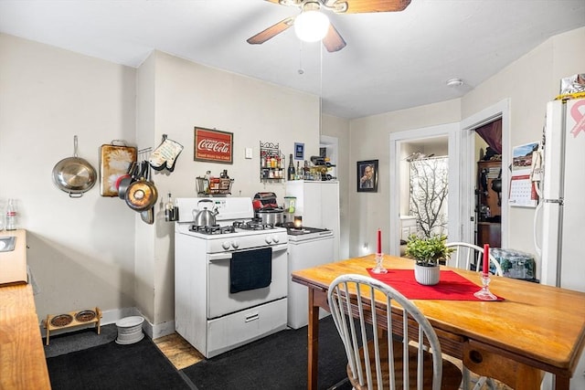 kitchen featuring white appliances, ceiling fan, and baseboards