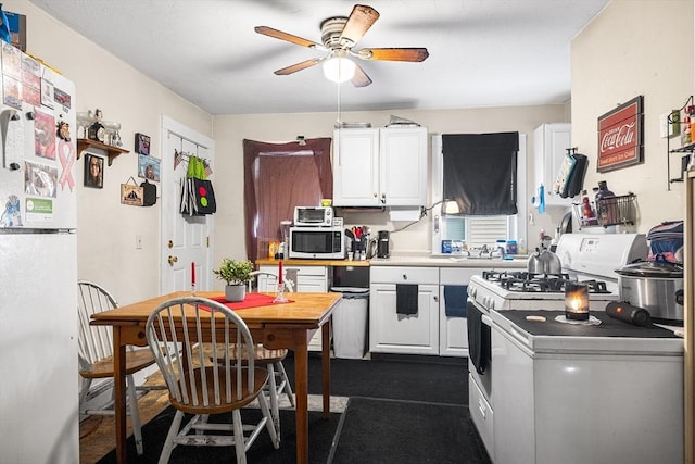 kitchen featuring ceiling fan, white appliances, and white cabinets