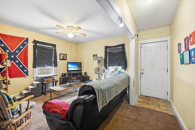 bedroom featuring dark carpet, baseboards, and ceiling fan