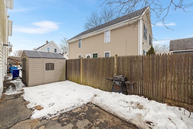 exterior space with a storage unit, an outdoor structure, and a fenced backyard